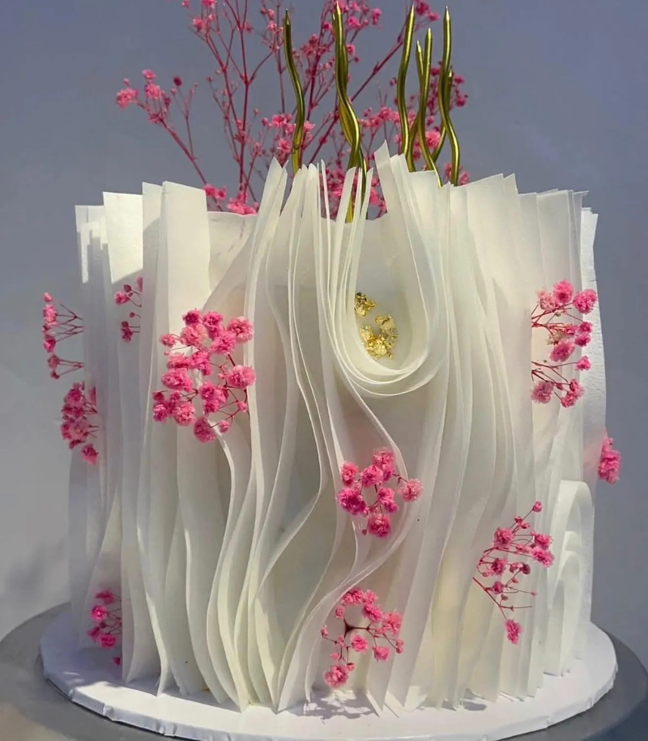 Delicate cake with pink wafer paper flowers